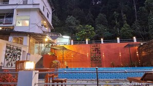 A building with a pool, stairs, and a balcony. - Tree Blanche Munnar (Devikolam)