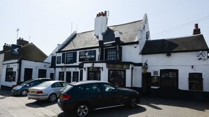 A traditional pub with a sign for "White Hart Inn" and "Guesthouse" on the facade. - The White Hart Inn (Twickenham)