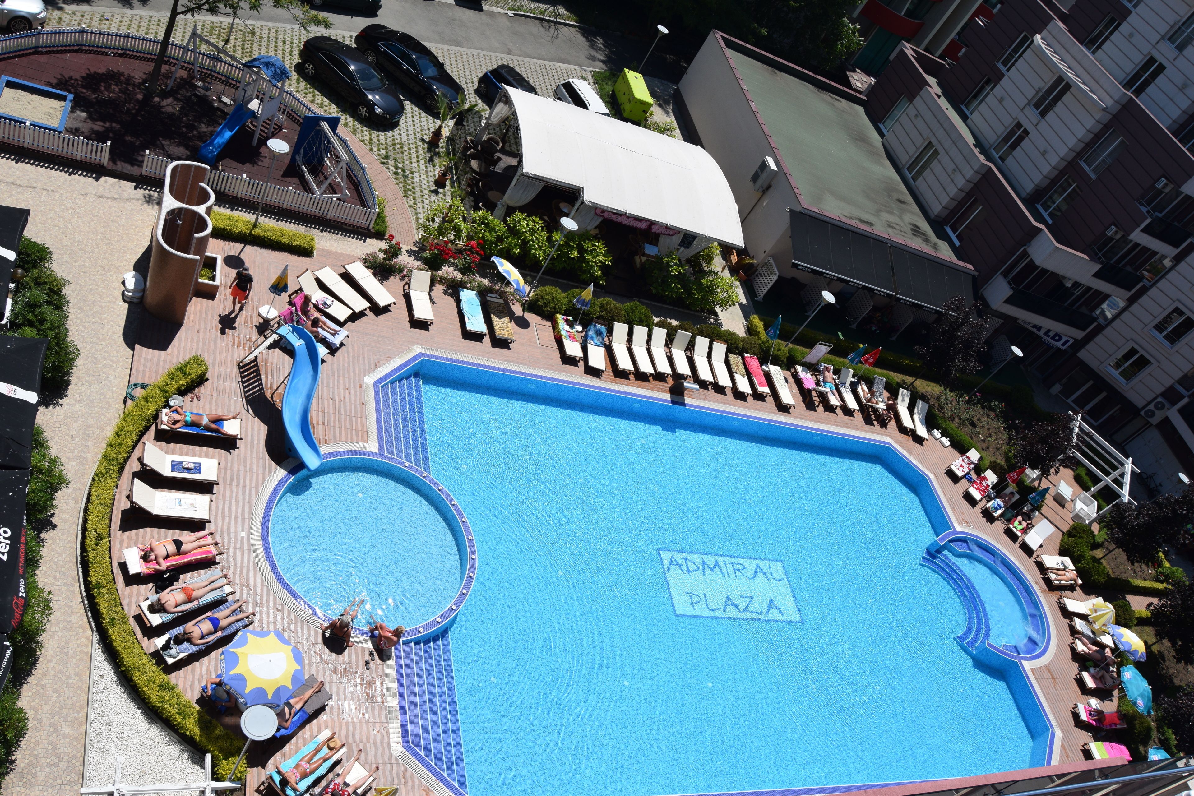 Una piscina al aire libre, sillones reclinables de piscina