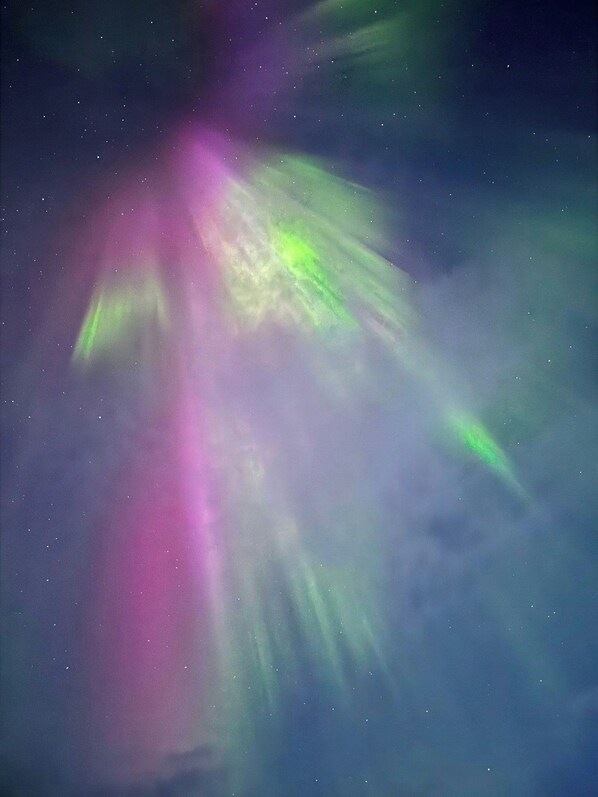 A starry night sky with visible aurora borealis.