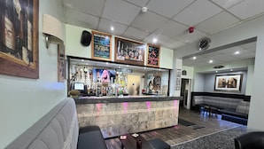 A bar area with a reception desk, seating, and a display of vodka bottles. - Fairhaven Hotel Central Blackpool (Blackpool)