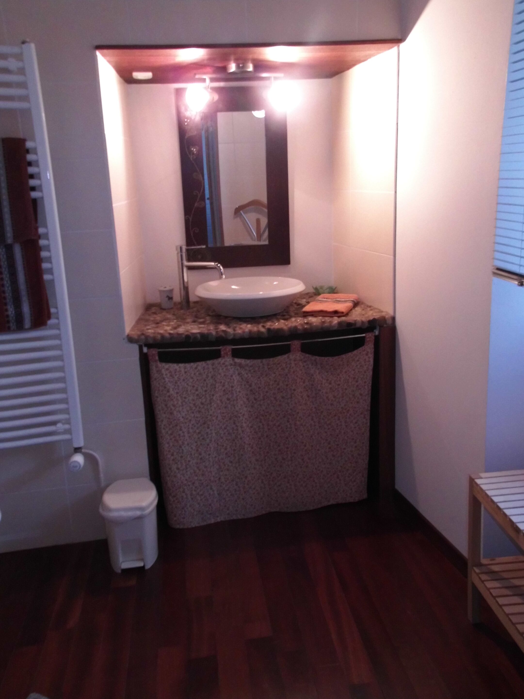 A bathroom with a sink, mirror, and toilet.