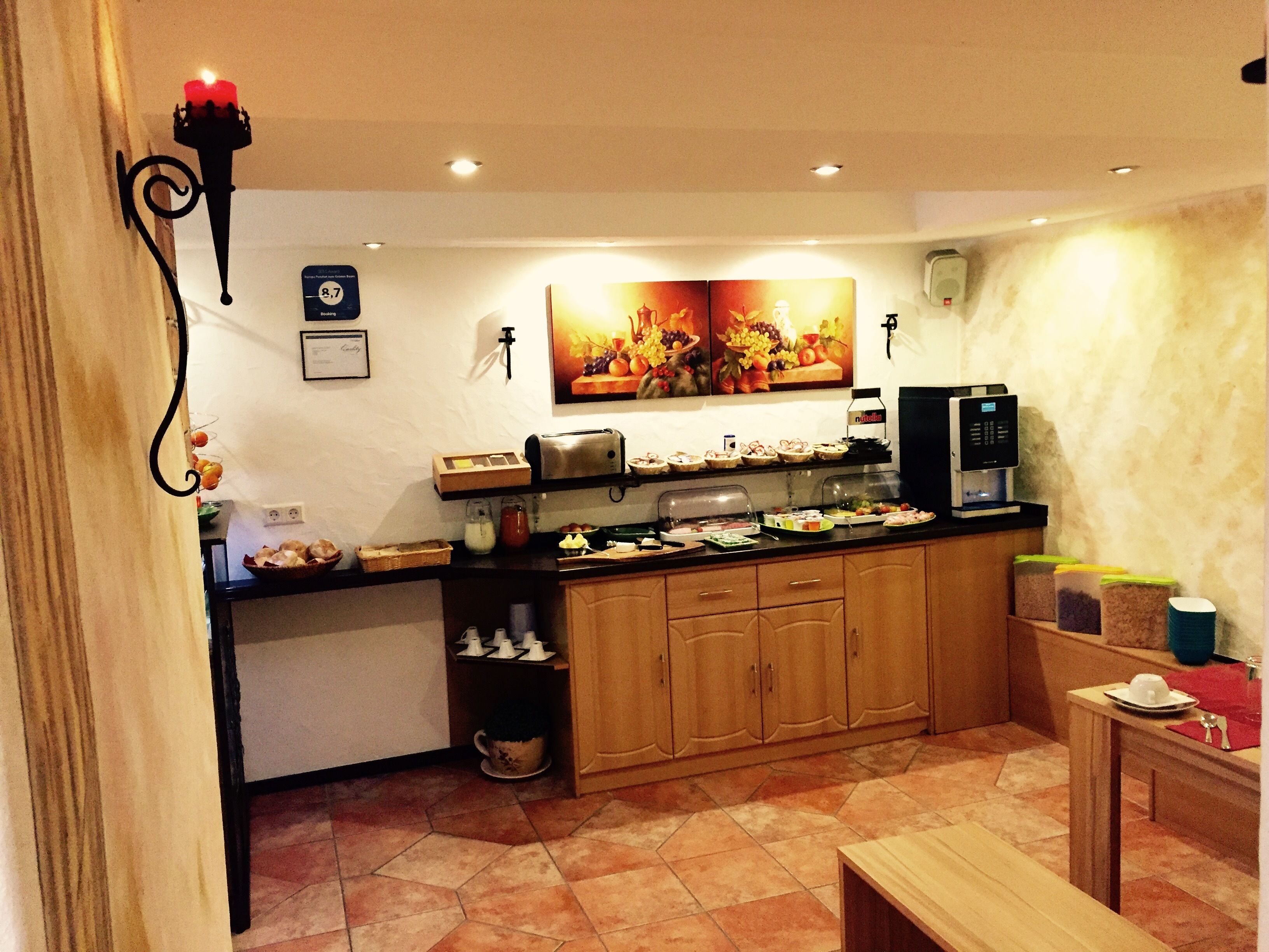 A kitchen with a coffee machine, a toaster, and a fruit display.
