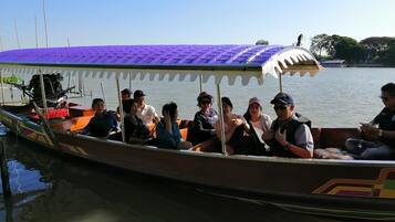 A boat with a purple roof and passengers.