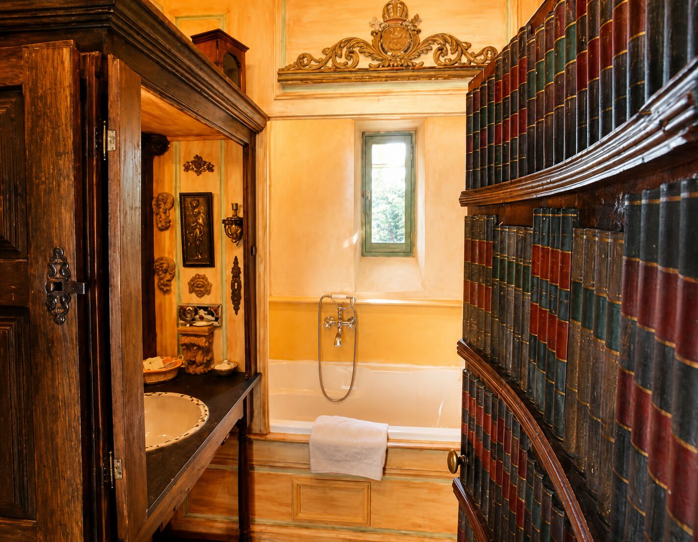 A bathroom with a bathtub, a wooden vanity, and a bookshelf filled with books.