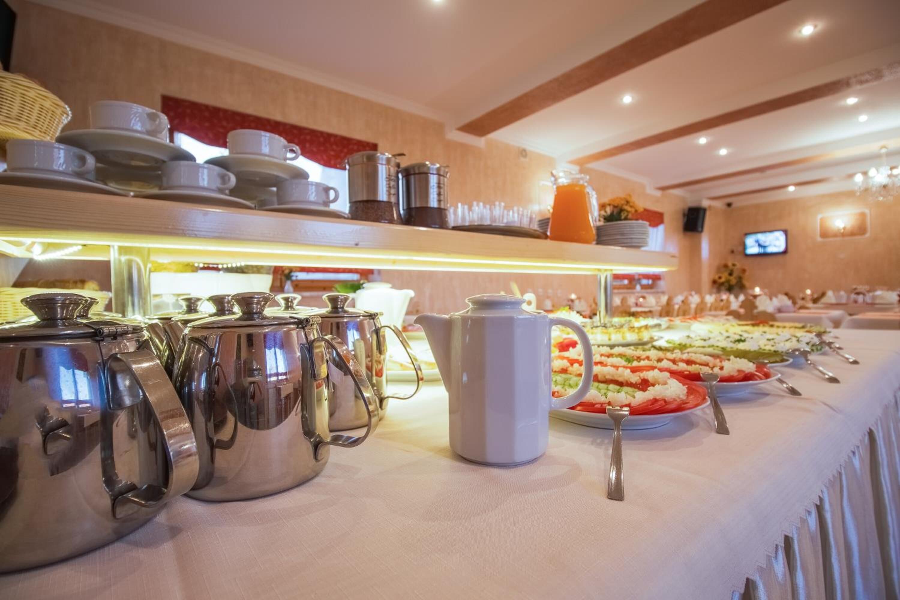 A buffet setup with various food items and serving utensils.