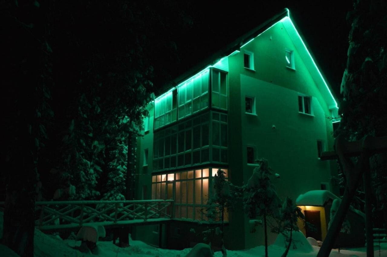 A multi-story building with a modern design, featuring large windows and a flat roof.