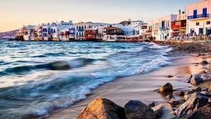 A coastal town with colorful buildings along the waterfront. - Mykonian Breeze (Mykonos)