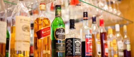 A variety of liquor bottles on a shelf.