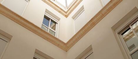 A high ceiling with skylights and multiple windows, suggesting a spacious interior with natural light.
