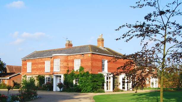 A large, two-story brick house with a well-maintained lawn and a gravel driveway. - Park Hill Hotel (Lowestoft)