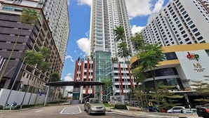 A high-rise building with a modern architectural design, featuring multiple floors and a prominent glass facade. - Ais Kacang Sweet Home Pinnacle Tower (Johor Bahru)