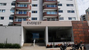 A multi-story hotel named 'EVEREST' with a modern design, featuring balconies on each floor and a covered entrance area.