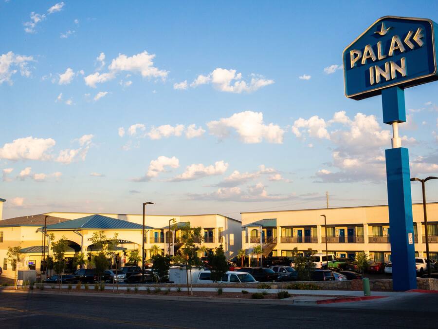 A hotel named "Palace Inn" with a clear sky and clouds.