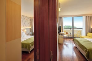 A hotel room with two beds, a desk, chairs, and a large window with a view. - Maistra Select Island Hotel Istra (Rovinj)