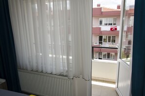 A balcony with a view of a building with balconies and windows. - Venüs Pansiyon (Çanakkale)