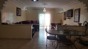Exclusive Apartment, 2 Bedrooms | Living area | 50-inch flat-screen TV with cable channels, TV