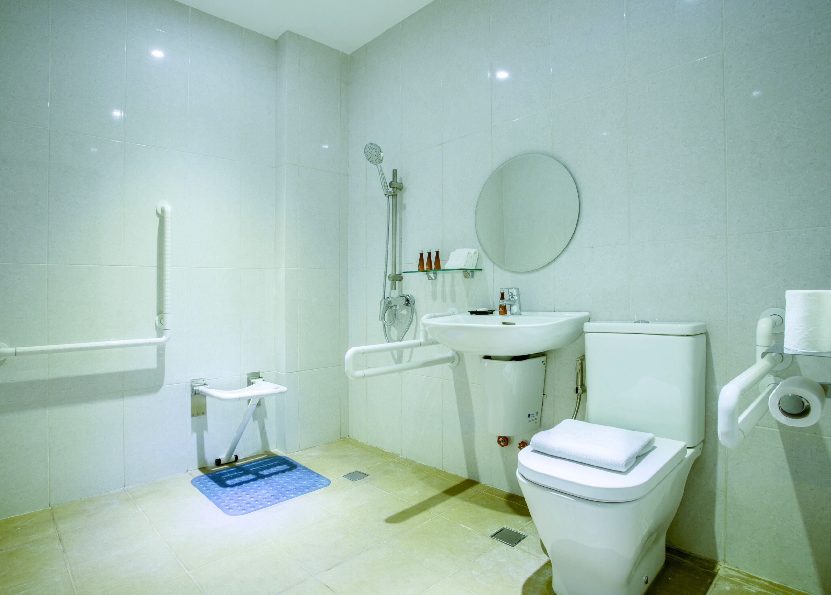 A bathroom with a toilet, sink, and shower.