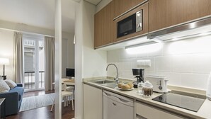A modern kitchen with a microwave, toaster, and coffee maker. - Downtown Funchal Apartments 1C Cedros. (Funchal)