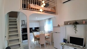 A modern apartment with a dining area, kitchen, and a balcony with a bed. - Apartment Kristina 400 m from the sandy beach + air condition + WiFi +dishwasher (Medulin)