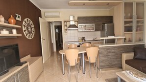A modern kitchen with a dining area, a TV, and a sofa. - Cozy Apartment • Pool • close to Trogir & Airport (Trogir)