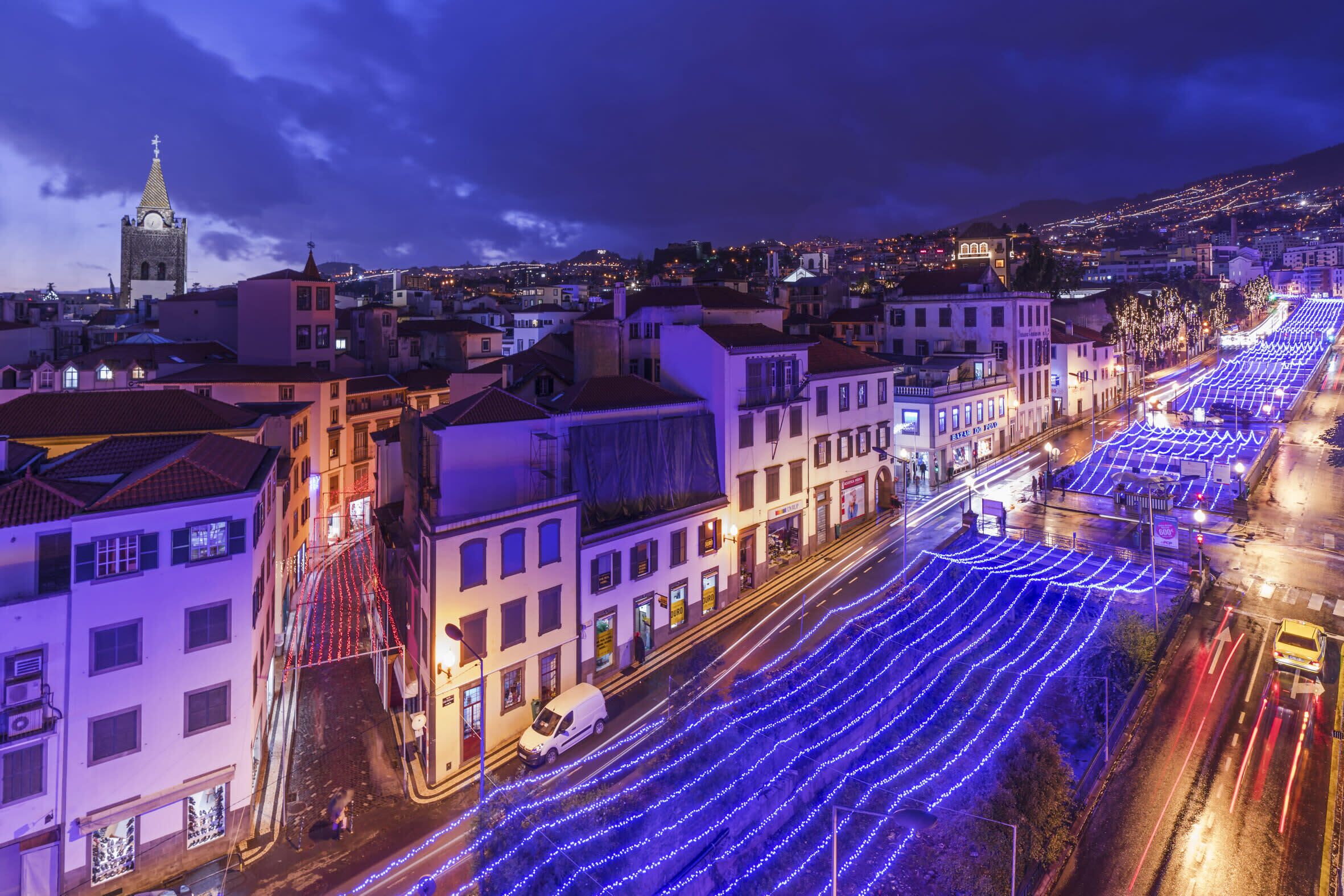 A cityscape at night with illuminated streets and buildings.