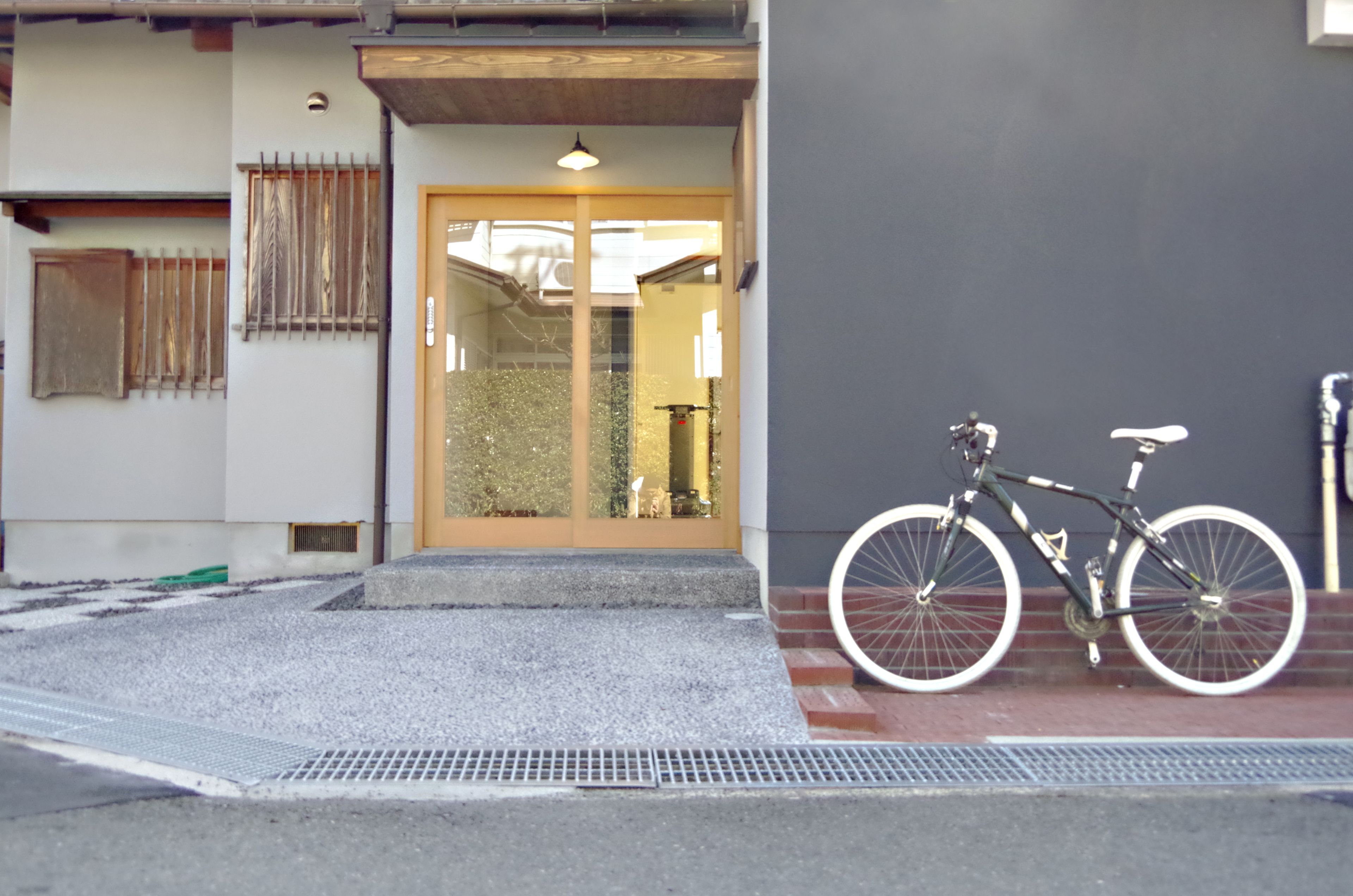 A building entrance with a bicycle parked outside.