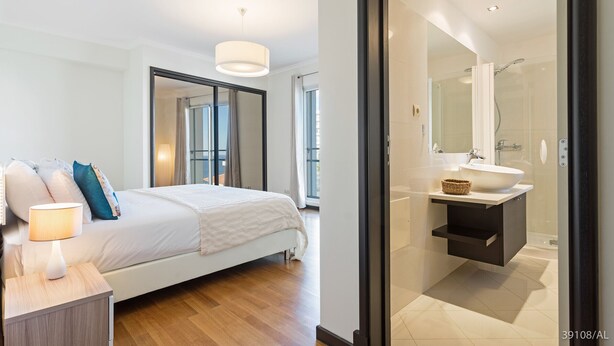 A modern bedroom with a large bed, bedside table, and a nightstand. - Rodamar I, the promenade, the beach and a sea view (Funchal)