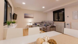 Una sala moderna con sofá, mesa de centro y mesa de comedor.