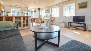 A spacious living room with a round black table, a sofa, and a television on a stand. - Lovely home in Vordingborg with WiFi (Vordingborg)