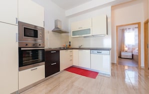 Enjoy cooking and dining in this well-lit kitchen with an oven and microwave.