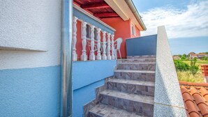 A staircase leading to a red-roofed building with a blue wall. - 2 bedroom awesome apartment in Vodnjan (Vodnjan)