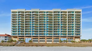 A multi-story hotel with balconies, located near a beach. - Spacious Oceanfront Condo, Jacuzzi Tub, Lazy River | Mar Vista Grande - 1206 (North Myrtle Beach)