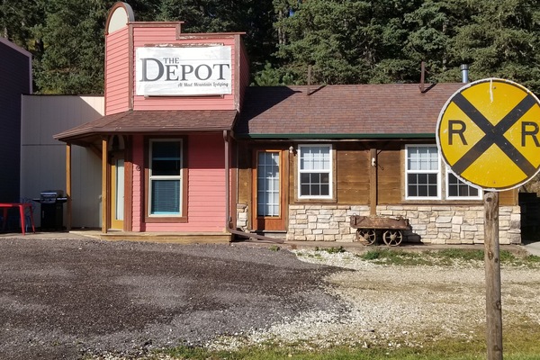 the front access door is to the left, under the porch.