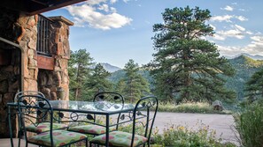 Sit and take in the breathtaking views of the surrounding mountains from this outdoor seating area.