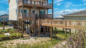 A two-story house with a wooden deck and a balcony. - Next to Sea Gallery | Group Favorite! Ocean Front + Original Artwork (Topsail Beach)