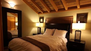A well-lit hotel room with a large bed, two bedside tables, and a wooden ceiling. - Modern Hotel-Like Luxury! 3 Bed+Loft. Twin Units  Book Separately 329292 (Mammoth Lakes)