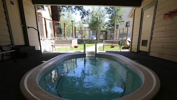An indoor swimming pool with a view of a backyard patio area. - Modern Hotel-Like Luxury! 3 Bed+Loft. Twin Units  Book Separately 329292 (Mammoth Lakes)