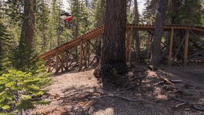 A mountain biking trail with wooden structures and dense forest. - Modern Hotel-Like Luxury! 3 Bed+Loft. Twin Units  Book Separately 329292 (Mammoth Lakes)