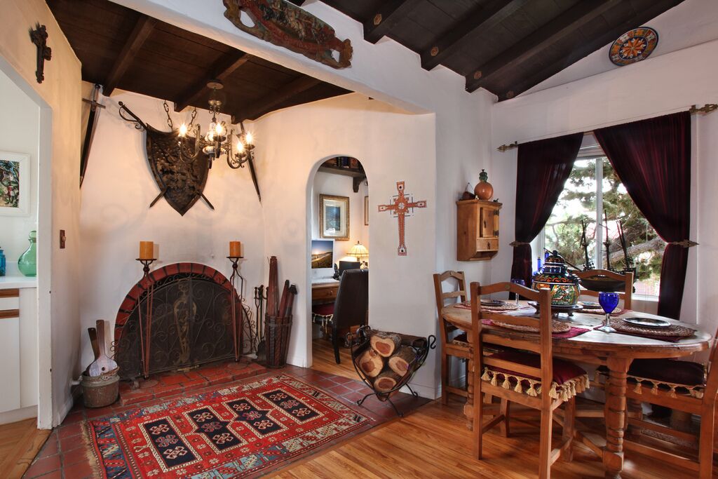A traditional interior with a fireplace, wooden furniture, and a rustic decor.