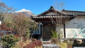 A traditional building with a tiled roof and a mural on the wall.