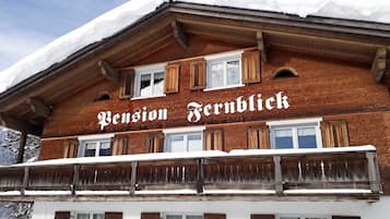 A traditional chalet with a sign reading 'Pension Fernblick.'
