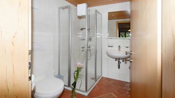 Shower, hair dryer, towels, toilet paper