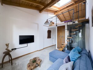 Balcony Suite 4 | Living area | Flat-screen TV