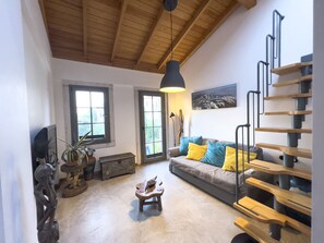 Balcony Suite 5 | Living area | Flat-screen TV