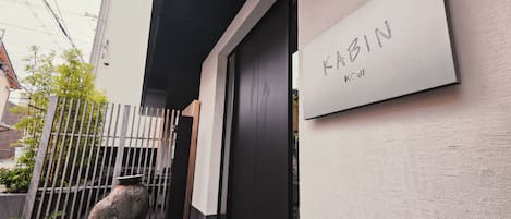 Una entrada moderna a un edificio con un cartel que dice "KABIN Kyoto".