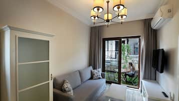 Apartemen, pemandangan kebun | Area keluarga | TV LCD