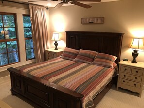 A bedroom with a large bed, two bedside tables with lamps, a ceiling fan, and a window with curtains. - Extra Lg 4 Bed & 5 1/2. BA, Great for families & couples! (Highlands)