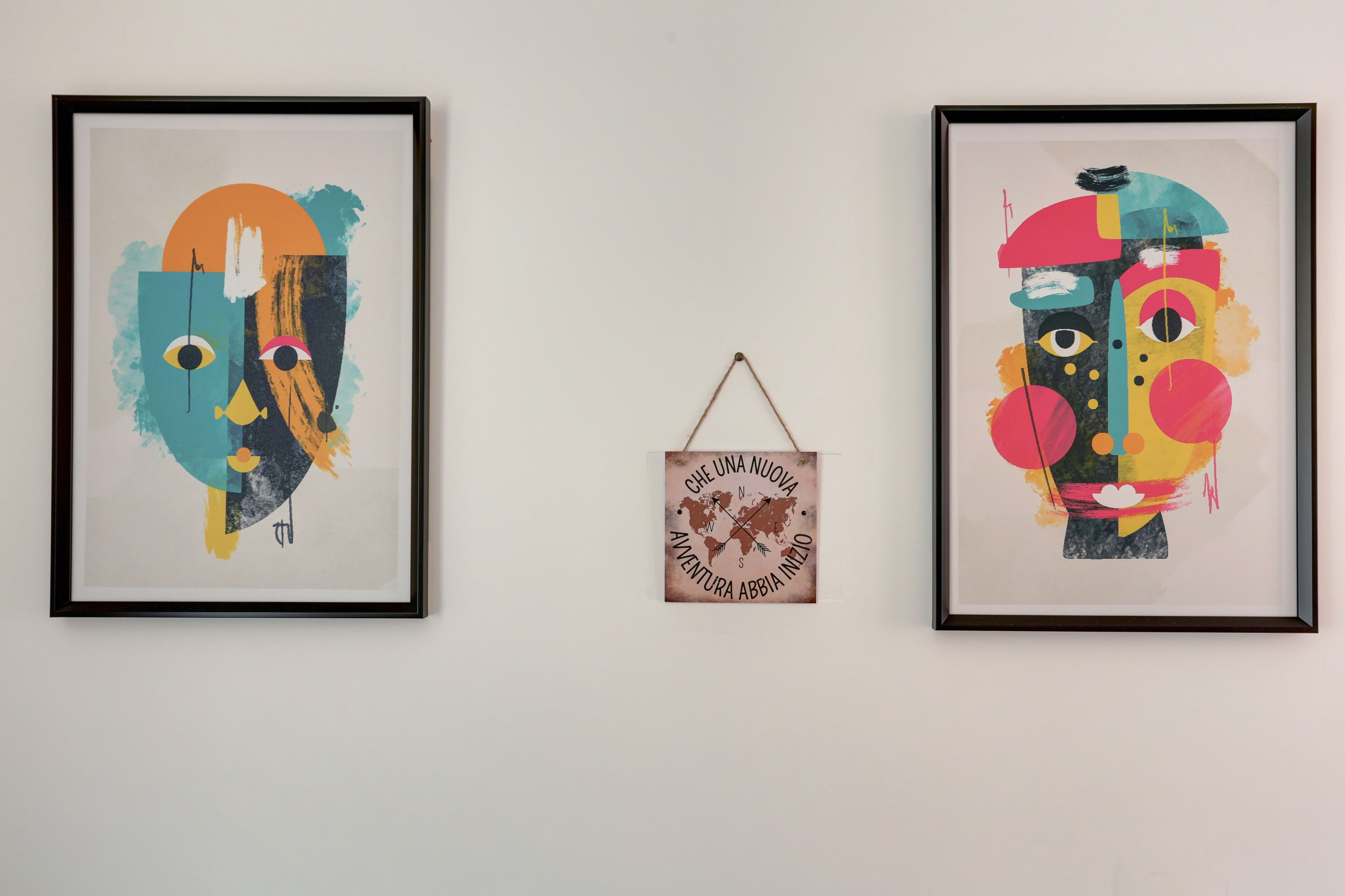 Two framed abstract artworks on a wall.