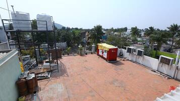 A rooftop with a red and white structure, possibly a water tank, and a metal scaffold.